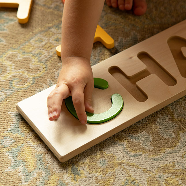 wooden name puzzle with pegs